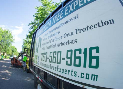 side view of truck with phone number - Minnesota Tree Experts Tree Trimming, Removal and Disease Care