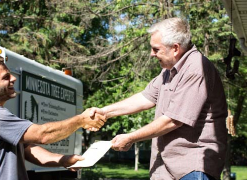 two guys shaking hands outside - Minnesota Tree Experts Tree Trimming, Removal and Disease Care